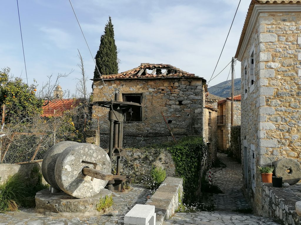 Traditional stone houses and old olive press in Exochori, Mani