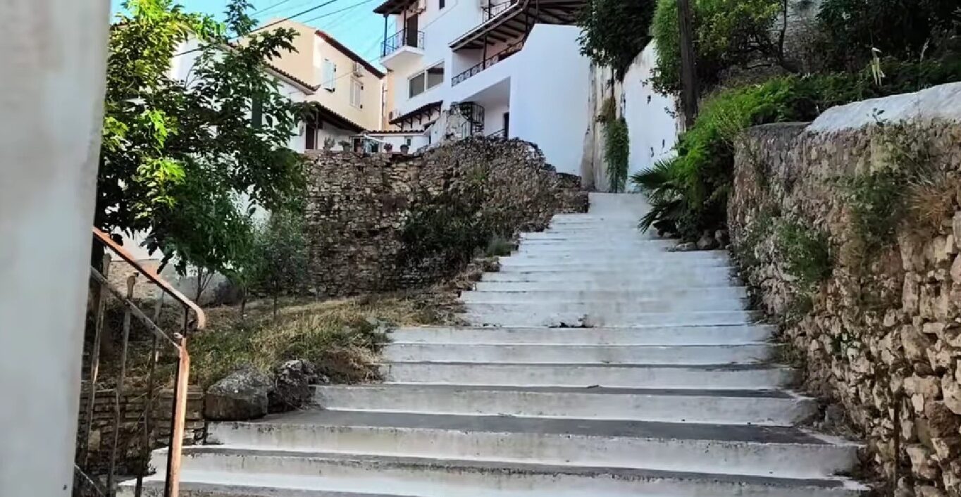Traditional narrow street climbing through the old town of Koroni