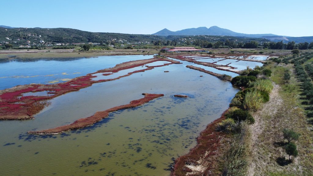 Aerial view of the shallow waters, salt marshes and natural landscape of Gialova Lagoon.